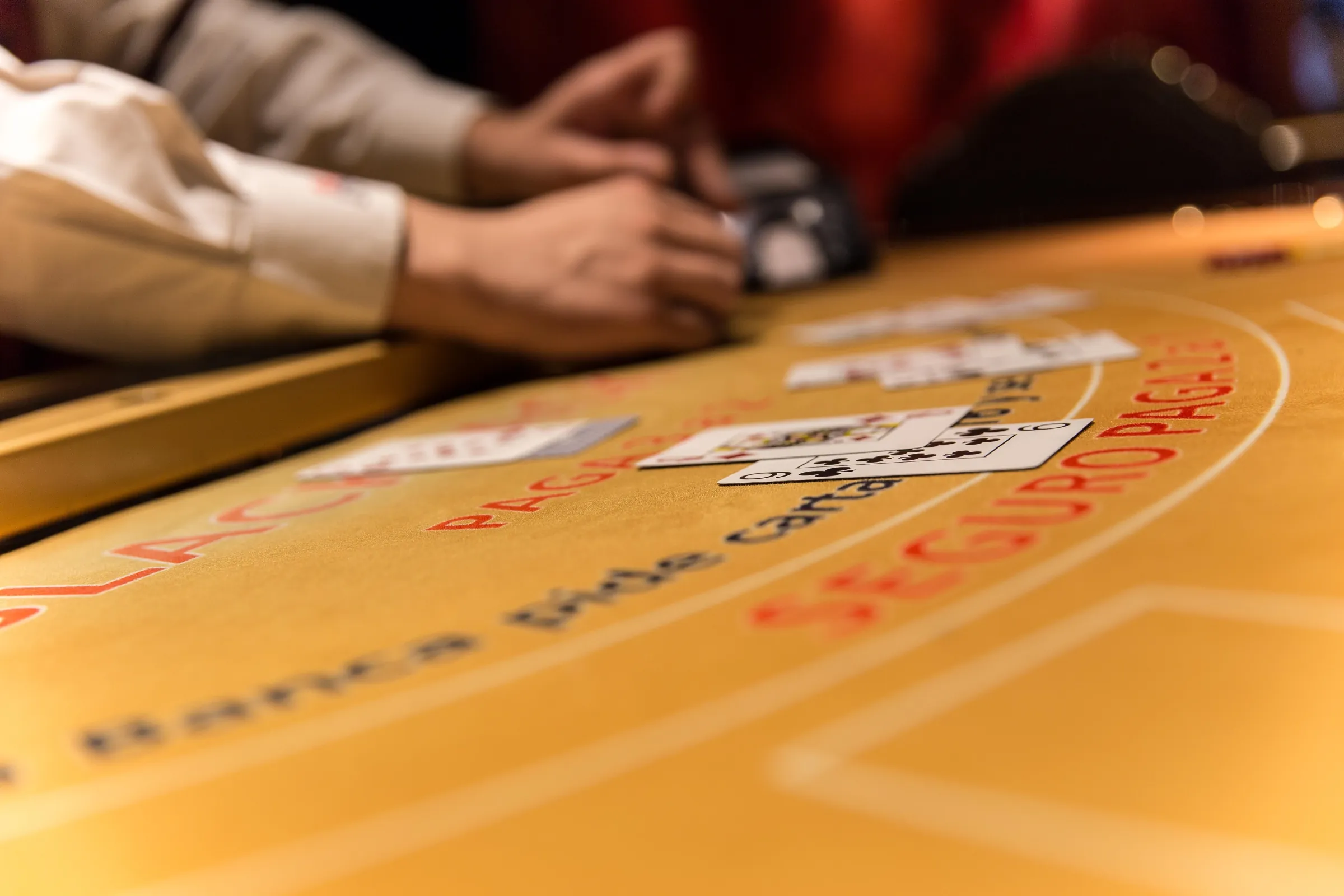 Cartas y manos sobre el paño de Black Jack en Casino Arena Maipú